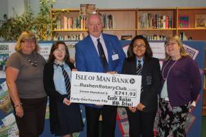 John Quaye, International Chairman receiving a donation for the Shelterbox Appeal from the staff and pupils of Castle Rushen High School library